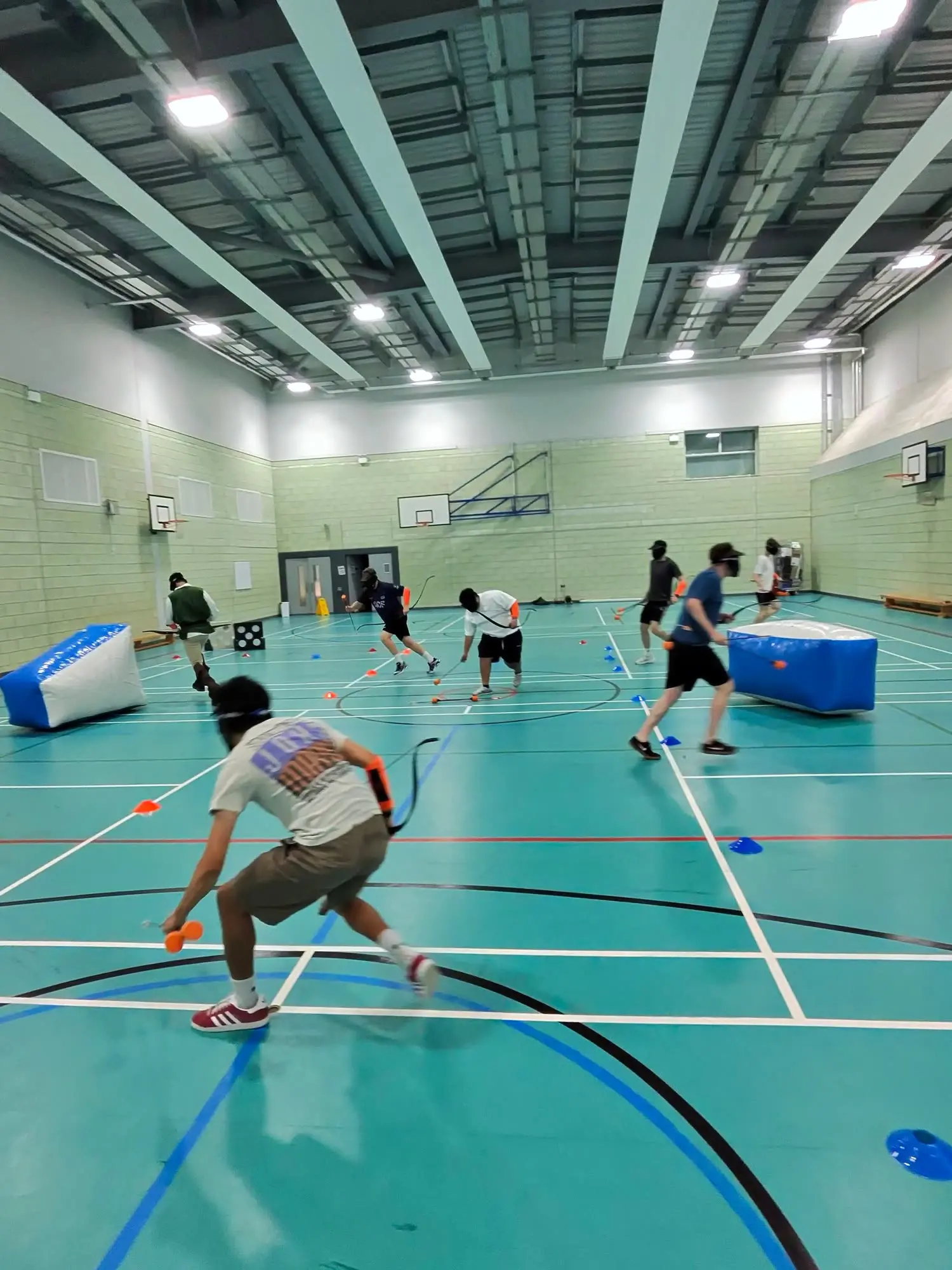 A player crouches low and aims during an indoor game